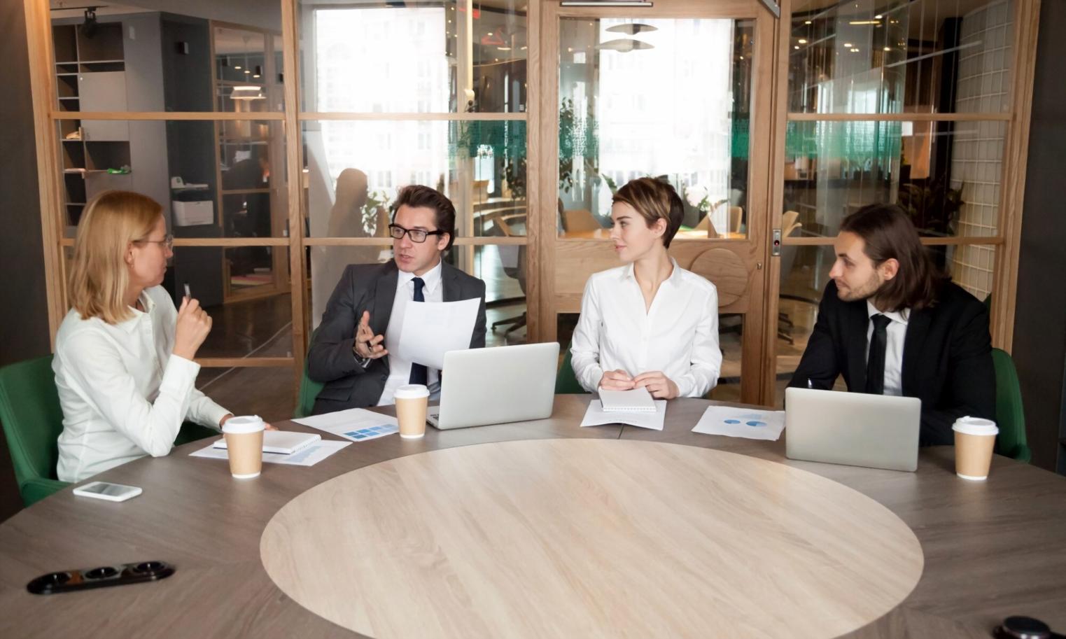 Financial professionals analyzing charts and data in modern office environment